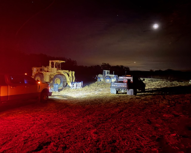 Heavy equipment and Parker Welding mobile rig working a job site after dark