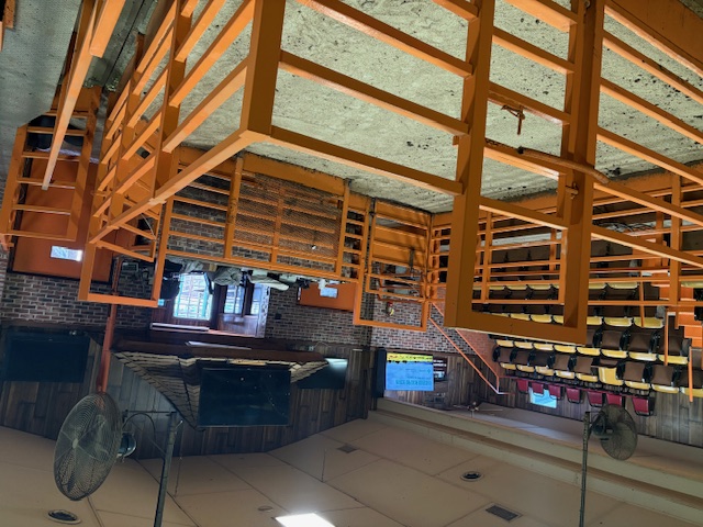 Painted structural steel interior framing of a large auditorium